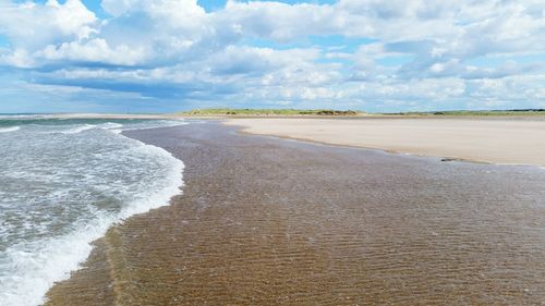 Scenic view of sea against cloudy sky