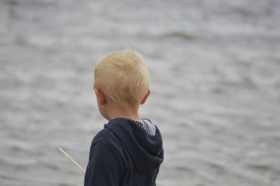 Rear view of boy at beach