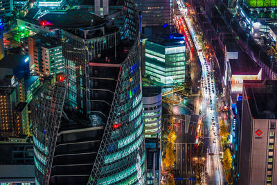 Aerial view of illuminated buildings in city at night