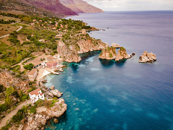 High angle view of rocks on sea shore against sky