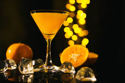 Close-up of wine glass on table against black background