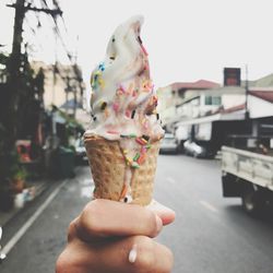 Close-up of hand holding ice cream cone