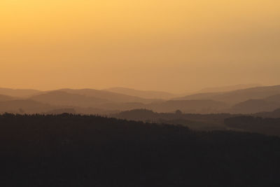 Silhouette landscape against sky during sunset