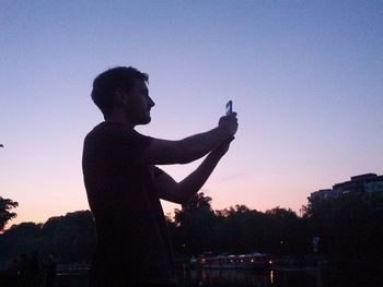 Low angle view of silhouette people against sky