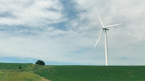 Windmill on field against sky