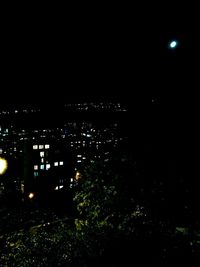 Illuminated cityscape against sky at night