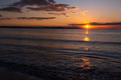 Scenic view of sea against romantic sky at sunset