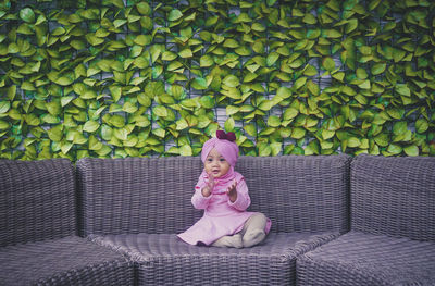 Portrait of cute girl sitting on sofa