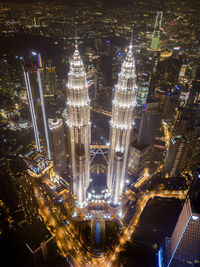 High angle view of city lit up at night