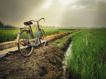 Bicycle on field against sky