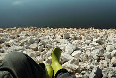 Rear view of man relaxing on rock