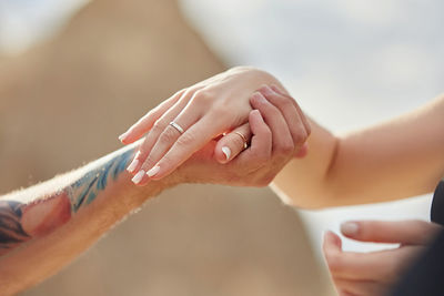 Close-up of couple holding hands