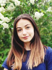 Portrait of smiling girl against trees