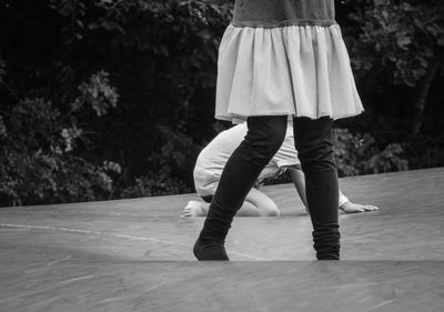 Low section of woman standing on a bouncy ball