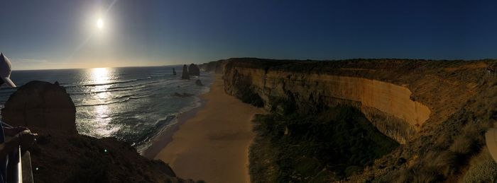 Panoramic view of beach against clear sky at sunset