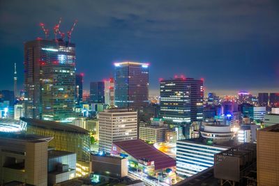 Illuminated cityscape of marunoucii, tokyo against sky at night
