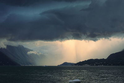 Scenic view of sea against storm clouds