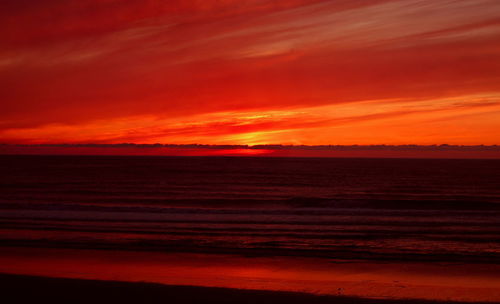 Scenic view of sea against orange sky