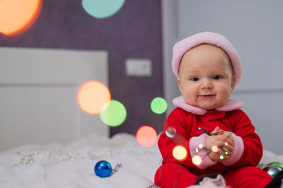 Portrait of cute baby boy playing with toys