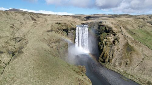 Scenic view of waterfall against mountain