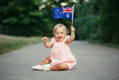 Baby girl waving australian flag. australia day holiday. celebration of national australia day 