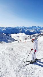 Woman skiing on snowcapped mountain during winter