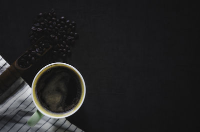 High angle view of coffee cup against black background