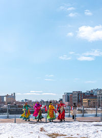 Group of people in front of building against sky