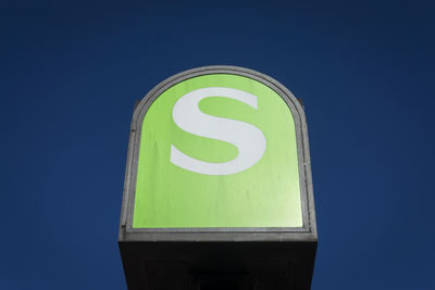 Low angle view of s-bahn road sign against blue sky