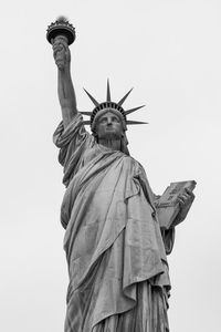 Low angle view of statue of liberty against clear sky