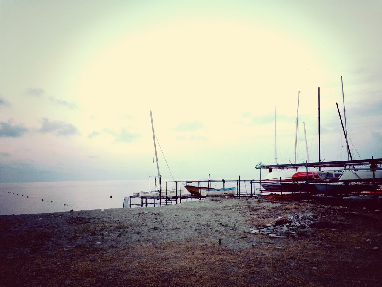 sea, water, nautical vessel, beach, boat, transportation, sky, horizon over water, moored, shore, mode of transport, sand, tranquility, tranquil scene, beauty in nature, scenics, nature, mast, sunset, cloud - sky