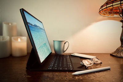 Electric lamp on table against wall at home