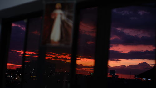 Reflection of sky on glass window at sunset