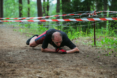 Full length of man climbing on field