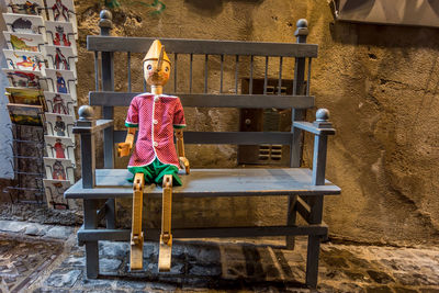 Portrait of boy sitting on table at bench