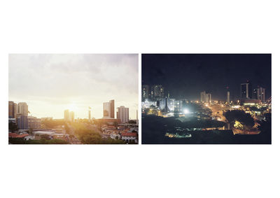 Digital composite image of illuminated city buildings against sky