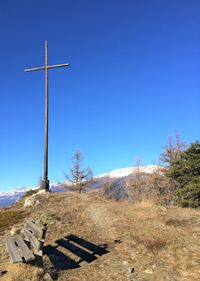 Low angle view of trees against clear blue sky