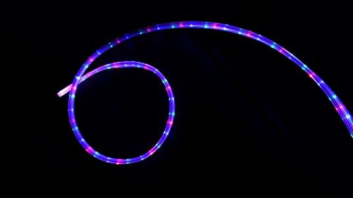 Close-up of illuminated light against black background