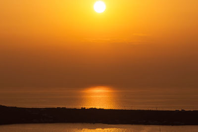 Scenic view of sea against romantic sky at sunset