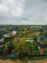 High angle view of buildings and trees against sky