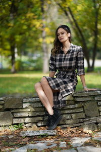 Portrait of a young woman sitting outdoors