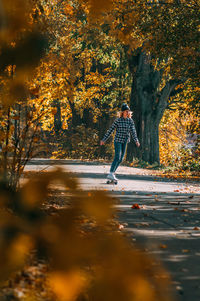 Full length of man standing by tree during autumn