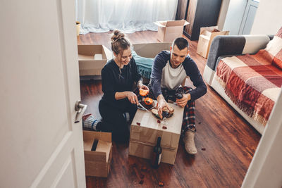 High angle view of men sitting on sofa at home