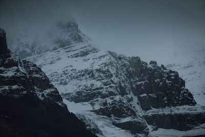 Scenic view of snow covered mountains against sky