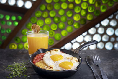 Majado, plantain mash with fried eggs, tomatoe sauce and orange juice, ecuadorian breackfast