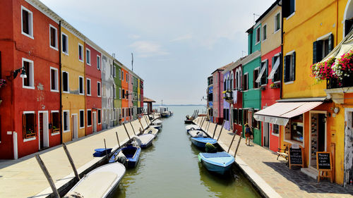 Boats in canal with buildings in background