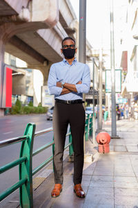 Full length of young man wearing sunglasses standing outdoors