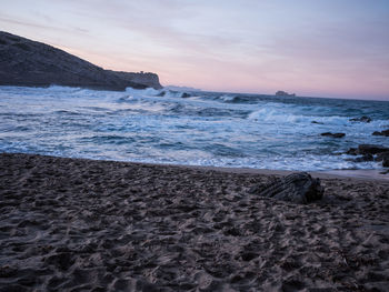 Scenic view of beach against sky during sunset