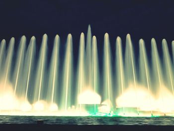 Illuminated fountain at night