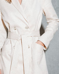 Close-up of woman standing against white background